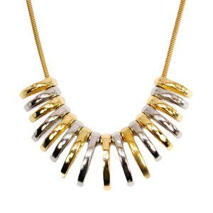 Silver and gold necklace with dome shape metal links attached to a snake chain